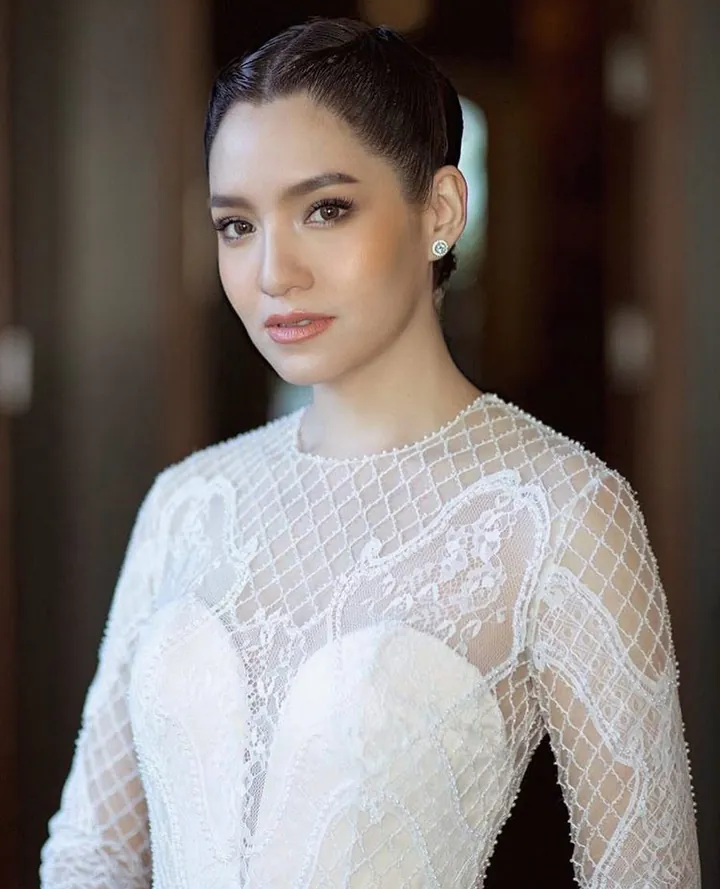 Portrait of a bride in a high-necked sheer top embroidered with a beaded lattice