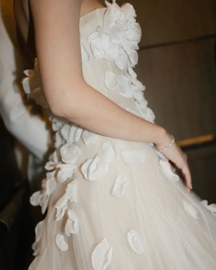 Close-up of a strapless bodice covered in three-dimensional fabric petals